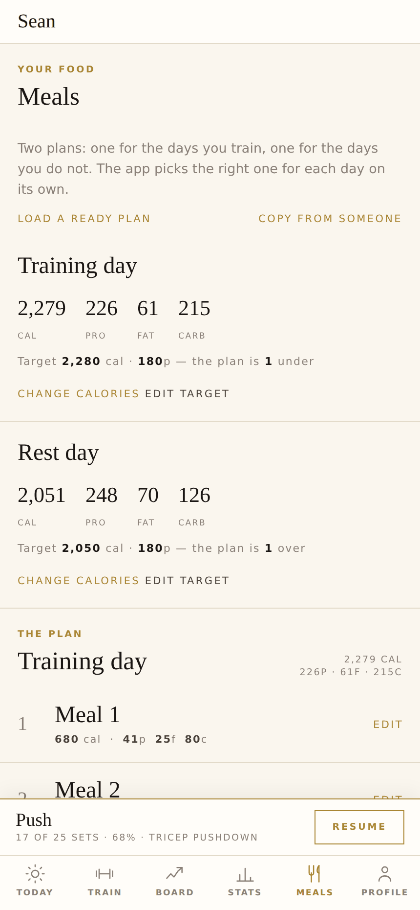 The Meals screen: a training-day plan and a rest-day plan side by side with calories, protein, fat and carbs against target.